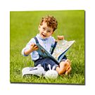 Square photo print of a family photo featuring a small boy reading a book