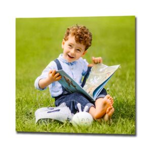 Square photo print of a family photo featuring a small boy reading a book