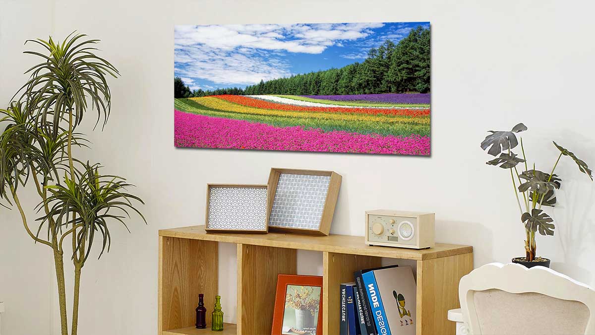 Floral landscape printed onto a panoramic poster and hung above a bookcase