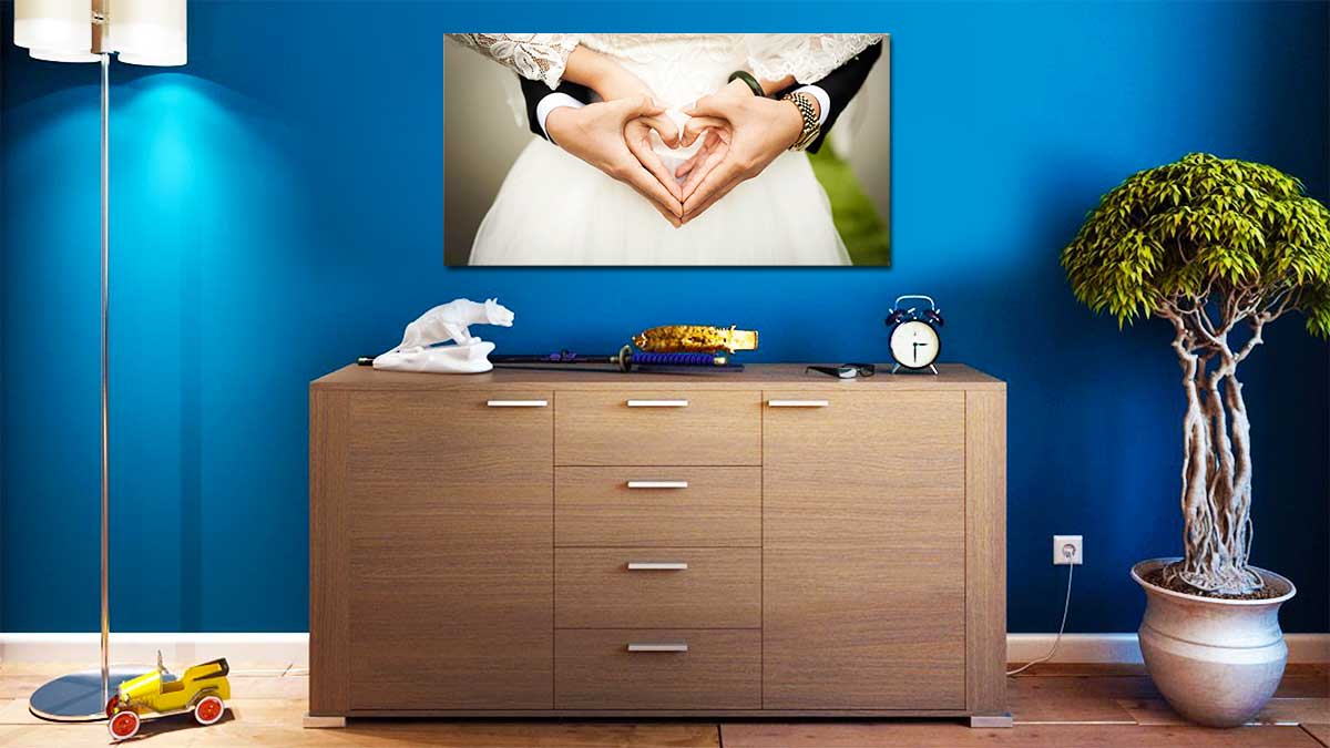 panoramic print of a wedding couple with their hands in a heart shape, hung over a sideboard