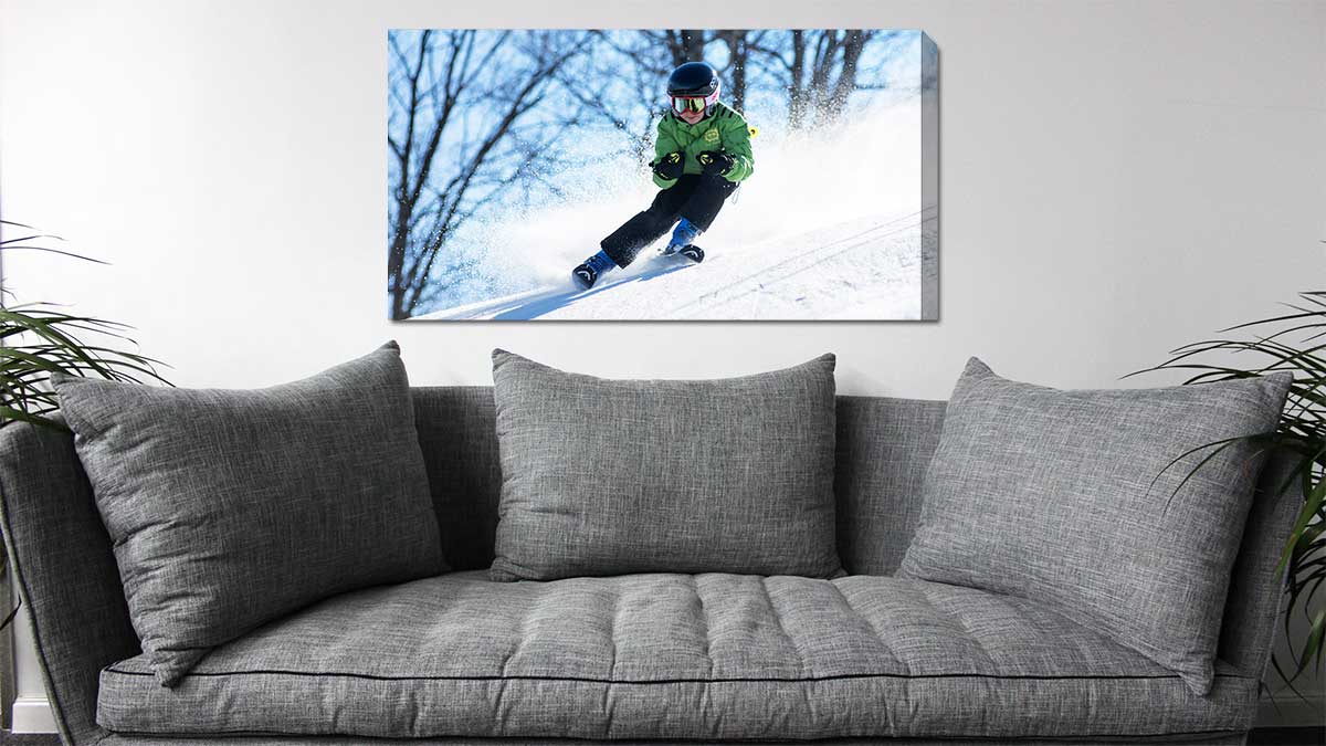Family ski photo of a child in the snow taken with an iPhone, then printed on canvas and hung over a sofa