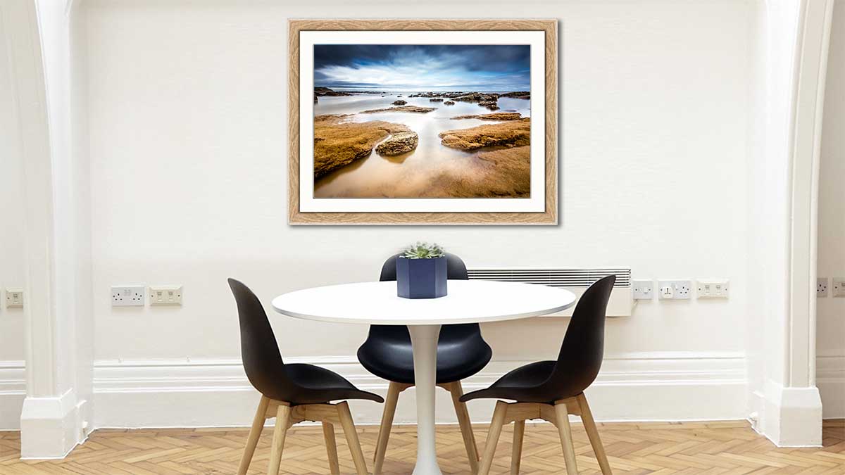 Picture of a seascape in an A1 oak frame and hung above a dining table