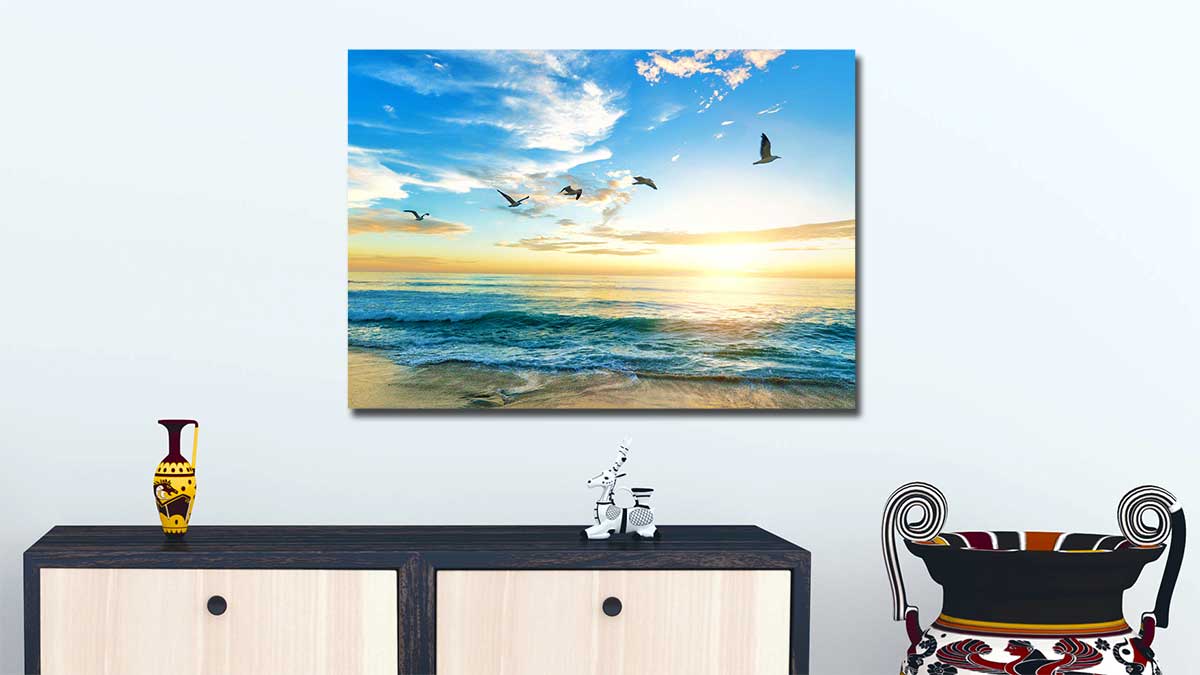 Sunset seascape taken with a phone and printed onto a standard poster, hung on a wall above a sideboard