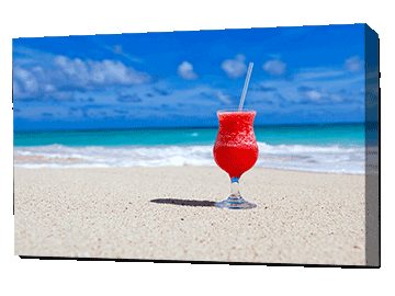 Quirky image of a cocktail glass on the beach printed on canvas