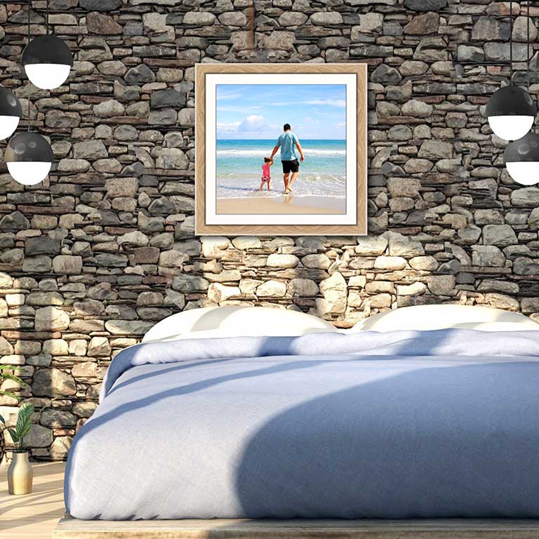 Family snapshot in an oak frame hung in a master bedroom