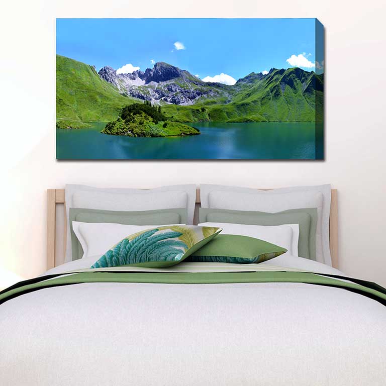 Beautiful landscape of a lake with hills behind hung over a double bed