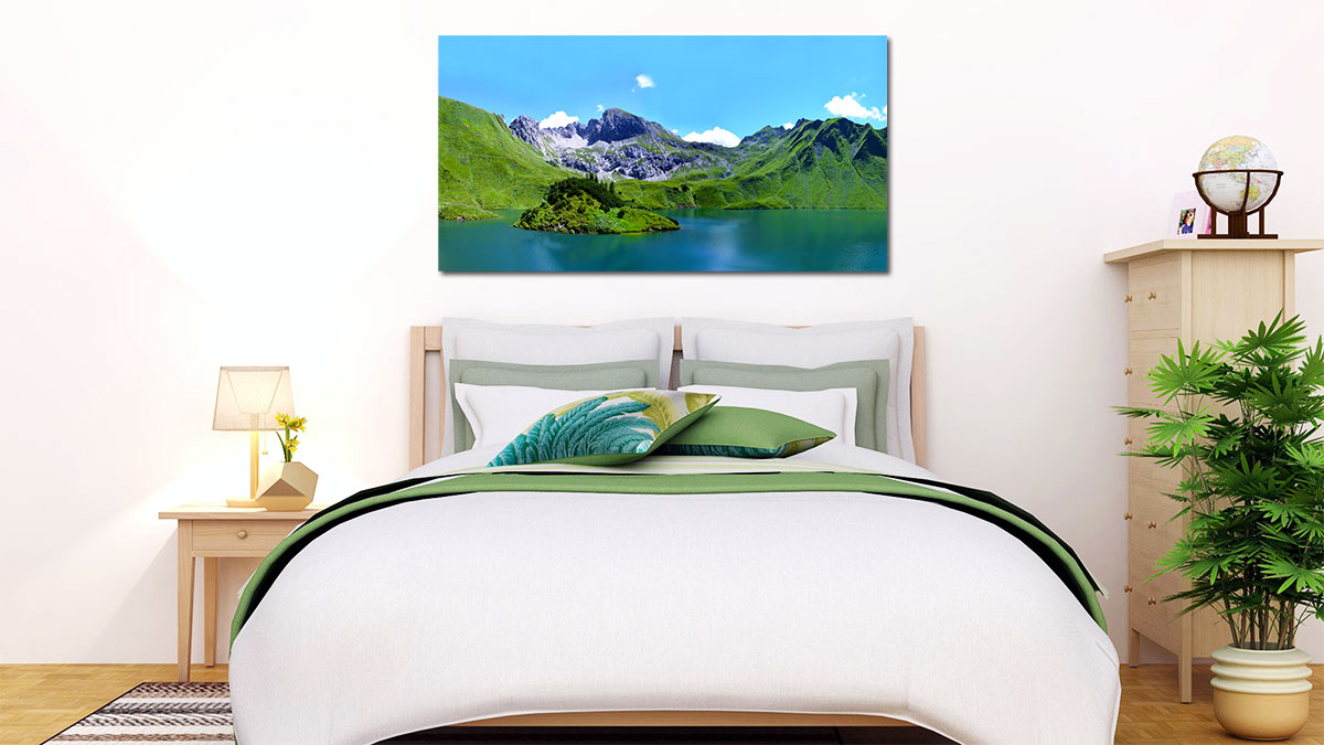 Panoramic poster of a mountain landscape hung above a bed