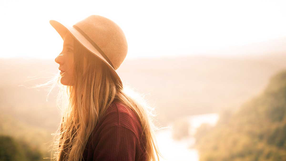 A girl in a photo beautifully backlit so that her face shows with soft light showing through her hair