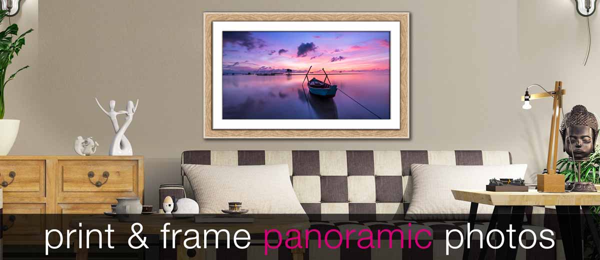 Panoramic photo of a boat in sunset in a wood frame in a stylish sitting room