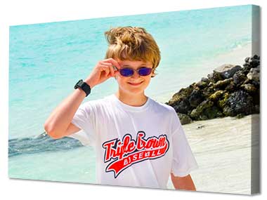 Quirky image of young lad on the beach printed on canvas