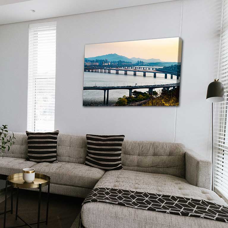 A family sitting room with a canvas print of a landscape holiday picture hanging on the wall.
