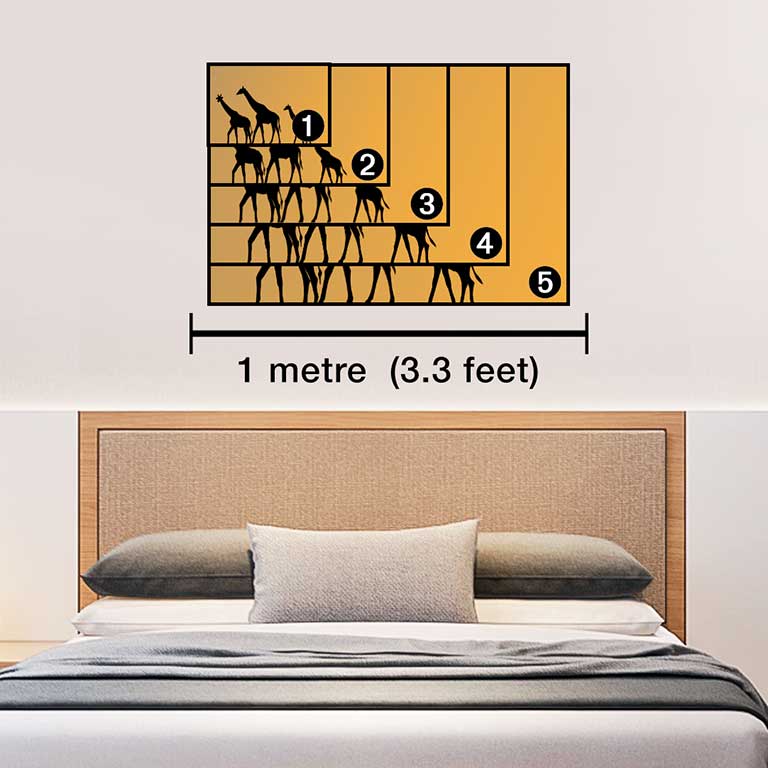Photo of a giraffe printed on a poster hung above a bed