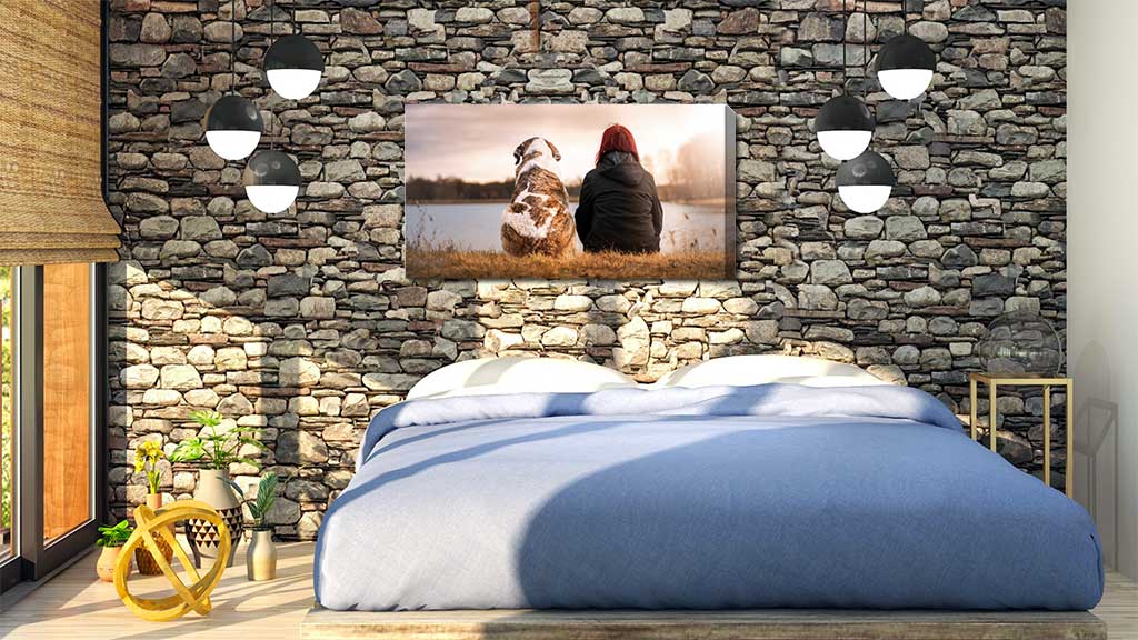 Bedroom wall with a canvas featuring a woman and her dog