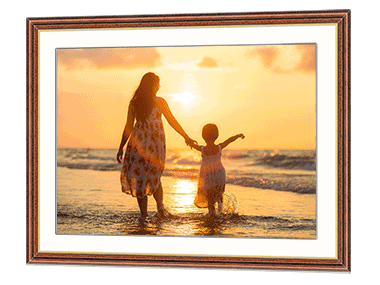 Frame with a picture of a mother and daughter playing in the sea