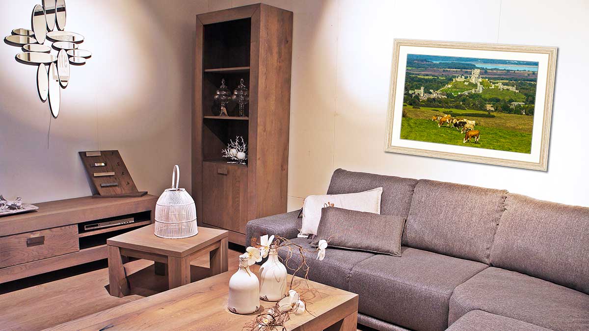Picture of an ancient castle with cows in the foreground hanging on a wall in a comfortable sitting room